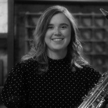 Bella smiling, holding her saxophone