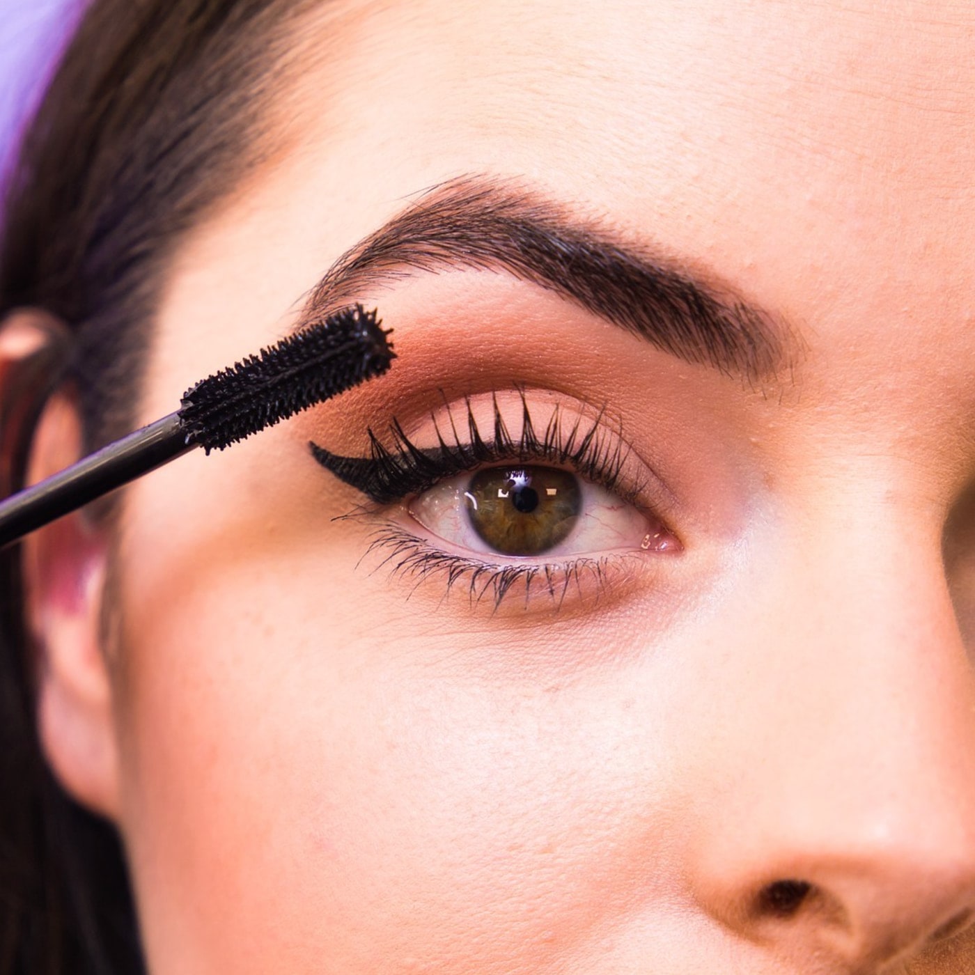 Close-up of mascara being applied to Abbey’s eyelashes